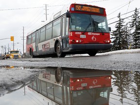 An OC Transpo bus drives along Scott St. near McRae Ave in Ottawa on Tuesday January 14, 2014. Darren Brown/Ottawa Sun/QMI Agency