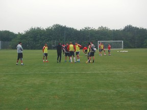 Toronto FC’s defensive unit comes together for a discussion during a drill on Tuesday. (KURTIS LARSON/Toronto Sun)