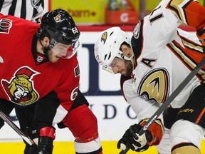 Ottawa Senators' Mike Hoffman wins the draw against Anaheim Ducks' Ryan Kesler during NHL hockey action at the Canadian Tire Centre in Ottawa, Ontario on Friday December 19, 2014. Errol McGihon/Ottawa Sun/QMI Agency