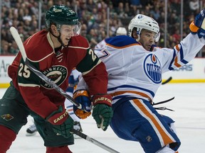 Wild defenceman Jonas Brodin tangles with Benoit Pouliot during the first period of Tuesday's game in St. Paul, Minn. Brodin and Oiler defencemen Oscar Klefbom grew up together in Sweden. (USA TODAY SPORTS)