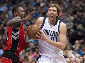 Mavericks’ Dirk Nowitzki (right) drives to the basket past Raptors’ Terrence Ross during the second quarter in Dallas last night. (USA Today)