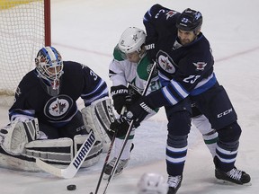 Dallas Stars left winger Antoine Roussel (c) has a shot blocked by Winnipeg Jets goalie Michael Hutchinson (l) and defenceman Jay Harrison  during NHL hockey in Winnipeg, Man. Tuesday, February 24, 2015.
Brian Donogh/Winnipeg Sun/QMI Agency