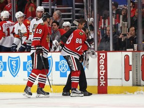 Blackhawks forward Patrick Kane is helped off the ice in front of captain Jonathan Toews after being cross-checked during first period NHL action against the Panthers in Chicago on Tuesday, Feb. 24, 2015. (Jonathan Daniel/Getty Images/AFP)