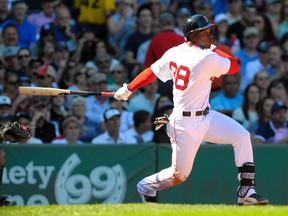 Boston Red Sox center fielder Rusney Castillo (38) hits an RBI single during the second inning against the New York Yankees at Fenway Park. Bob DeChiara-USA TODAY Sports