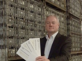 Red River Co-op General manager Doug Wiebe with equity cheques.