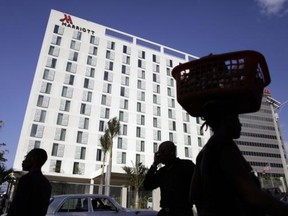 Pedestrians walk past the Marriott Port-au-Prince Hotel in Port-au-Prince February 24, 2015. Reuters/Andres Martinez Casares