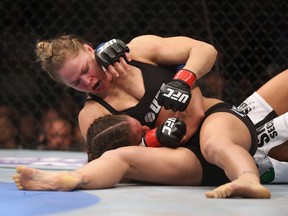 Ronda Rousey grapples with Liz Carmouche during their UFC bantamweight title fight at Honda Center February 23, 2013 in Anaheim, Calif. (Jeff Gross/Getty Images/AFP)