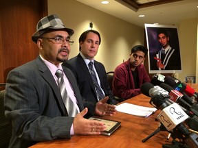 Lawyer Michael Smitiuch, middle, with Prashant Tiwari's father, Rakesh, and brother, Gautam. (CRAIG ROBERTSON/Toronto Sun)