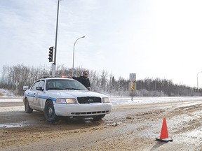 Peace officer Corey Munroe keeps Highway 21's southbound lanes at the Whitemud extension blocked following a fatal collision in Strathcona County, Alta. on Wednesday, Feb. 25, 2015. The passenger of a southbound 2003 Chevrolet Avalanche was killed when the vehicle lost control, crossed the highway's centre line, and was struck by a northbound Pontiac Grand Am. Michael Di Massa/Sherwood Park News/QMI Agency