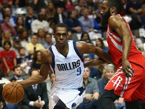Rajon Rondo #9 of the Dallas Mavericks dribbles the ball against James Harden #13 of the Houston Rockets at American Airlines Center on February 20, 2015 in Dallas, Texas.  Ronald Martinez/Getty Images/AFP