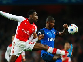 Arsenal's Danny Welbeck fights for the ball with AS Monaco's Almamy Toure during Champions League play Wednesday. (Reuters/Eddie Keogh)
