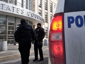 Police guard the Federal Courthouse in Brooklyn where two of three Brooklyn residents, who have been arrested for plotting to join extremists fighting in Syria and two threatened to carry out attacks within the US, are arraigned before a judge on Feb. 25. (AFP/JEWEL SAMAD)