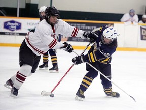 France Belanger of the College Notre Dame Alouettes tries to get a shot past St. Charles Cardinals defenceman Shaylene Peltier-Restoule during third period girls high school city championship action from Carmichael Arena on Wednesday afternoon.
