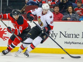 New Jersey Devils right wing Dainius Zubrus (8) and Ottawa Senators defenceman Patrick Wiercioch (46) battle for puck during the second period at the Prudential Center. Mandatory Credit: Jim O'Connor-USA TODAY Sports