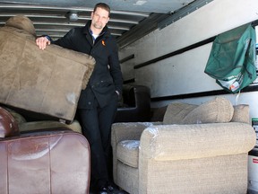 Andrew Barber, owner/operator of The Couch Doctor and Barber & Sons Residential with a truck full of water-damaged couches after a watermain break last Friday.  (Steph Crosier/The Whig-Standard)