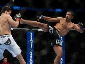 Mark Munoz (right) delivers a kick to the head of Demian Maia during their fight at UFC 131 at Rogers Arena in Vancouver, B.C., June 11, 2011. (Richard Lam/QMI Agency)