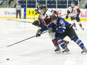 London Nationals forward Matt Bean and Chatham Maroons forward Jared Dennis battle for the puck during a game at the Western Fair Sports Centre last week. (CRAIG GLOVER, The London Free Press)