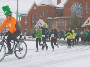 Wearing an oversized leprechaun hat, race volunteer Paul Lovelock  leads the second annual Shamrock Shuffle on Saturday in St. Thomas. The early-season race which benefits Inn Out of the Cold at Central United Church, raised over $17,000. (Eric Bunnell/QMI Agency/Times-Journal)