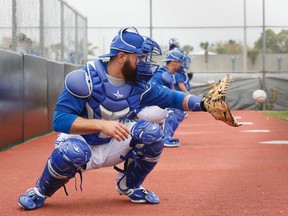 Russell Martin follows an R.A. Dickey pitch into his glove during his first bullpen session with the Blue Jays' knuckleball specialist on Wednesday in Dunedin. (STAN BEHAL, Toronto Sun)