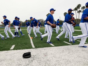 Blue Jays pitchers and catchers scatter after an onfield meeting on Wednesday. (STAN BEHAL, Toronto Sun)