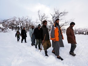 Relatives of avalanche victims return after conducting a search for the victims in Panjshir province, Feb. 25, 2015.  REUTERS/Omar Sobhani