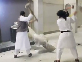 A video published online appears to show Islamist militants destroying a collection of priceless statues and sculptures dating to the ancient Assyrian era. (YouTube screengrab)