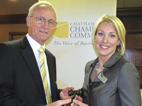 Outgoing Chatham-Kent Chamber of Commerce Chair Tony Hill passes the gavel to 2015 Chair Sarah Callow at the organization's annual general meeting, held on Thursday.