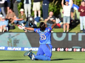 Afghanistan batsman Shapoor Zadran celebrates after hitting the winning runs to defeat Scotland in their 2015 Cricket World Cup Group A match in Dunedin on February 26, 2015. (AFP PHOTO / William WEST)