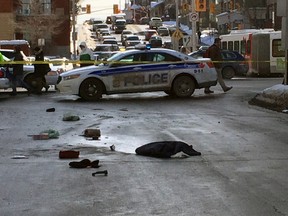 Police investigate along Rideau St., on Thursday after a pedestrian was struck and seriously hurt by a pickup truck. (TONY CALDWELL Ottawa Sun)