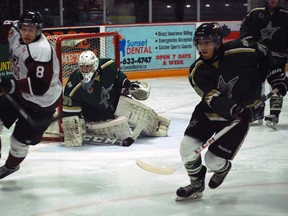 New St. Thomas Stars goalie Brendan Polasek watches as Chatham Maroons forward Jared Dennis, left, and Stars defenceman Reed Horvat chase the puck during the first period of a Stars home game at the Timken Centre. (File photo)