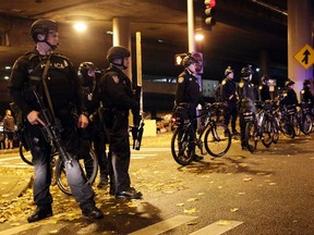 Seattle Police stop demonstrators from marching on the freeway following the grand jury decision in the Ferguson, Missouri shooting of Michael Brown, in Seattle, Washington November 24, 2014. The case has highlighted long-standing racial tensions not just in predominantly black Ferguson, Missouri but across the United States.  (REUTERS/Jason Redmond)