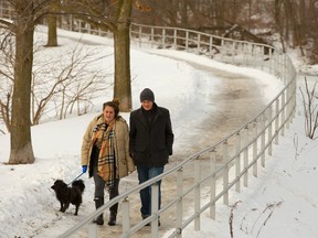 Britt Preston and Michael Haynes walk along the north branch of the Thames River near Blackfriar?s Bridge with their dog Charlie. Downtown resident Jim Taylor finds this walk along the river provides a great perspective on the city?s core. (Mike Hensen, The London Free Press file photo)