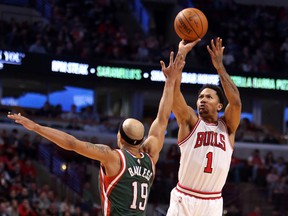 Chicago Bulls guard Derrick Rose makes a jump shot against Milwaukee Bucks guard Jerryd Bayless (19) in the second half during the game at United Center on Feb. 23, 2015. (Caylor Arnold/USA TODAY Sports)