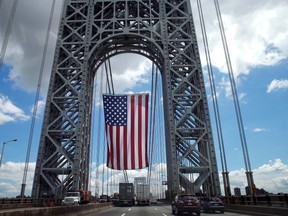 A giant American flag hangs from the West tower of the George Washington Bridge in between New York and New Jersey ahead of the U.S.-Germany 2014 World Cup Group G soccer match June 26, 2014. (REUTER/Mike Segar)