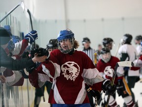 Frontenac Falcons defenceman Eric Labrie celebrates his team's final goal in the Falcons’ 4-1 win over the Holy Cross Crusaders in the Kingston Area boys hockey final at the Invista Centre Thursday. (Steph Crosier/The Whig-Standard)