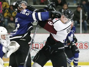 Chatham Maroons' Jared Dennis, right, and London Nationals' Tanner Lafrance tangle in front of Nationals goalie Justin Tugwell in the first period at Chatham Memorial Arena in Chatham. (Mark Malone/Chatham Daily News/QMI Agency)