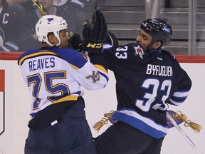 St. Louis Blues right winger Ryan Reaves (l) and Winnipeg Jets defenceman Dustin Byfuglien tangle during NHL hockey in Winnipeg, Man. Thursday, February 26, 2015.
Brian Donogh/Winnipeg Sun/QMI Agency