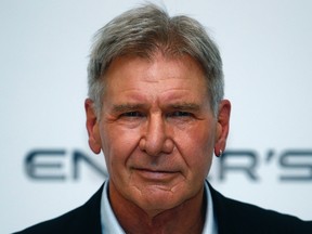 Actor Harrison Ford poses for photographers at a question and answer event about his new film "Enders Game" at a cinema at Leicester Square in central London in this file photo taken October 7, 2013. Ford has undergone surgery on his broken left leg that was injured in an accident on the set of "Star Wars: VII," the publicist for the 71-year-old actor said in a statement on Thursday.  REUTERS/Andrew Winning/Files