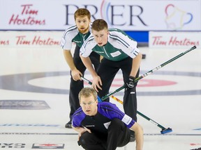 Wade Scoffin (third for skip Bob Smallwod) of Team Yukon eyes a shot in front of P.E.I.’s Robbie Doherty and Anson Carmody during Thursday’s qualifying draw at the Saddledome in Calgary. Lyle Aspinall/CALGARYSUN