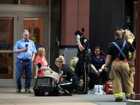 Emergency workers aid people outside City Centre Mall in Edmonton, Alta., on Wednesday, June 18, 2014.  Someone had let go some pepper spray inside the mall and patients were taken outside for recovery. Perry Mah/Edmonton Sun