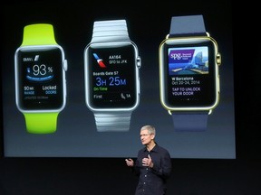 Apple CEO Tim Cook stands in front of a screen displaying apps available for the Apple Watch at a presentation at Apple headquarters in Cupertino, Calif., Oct. 16, 2014.  REUTERS/Robert Galbraith
