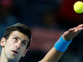 Novak Djokovic of Serbia serves to Tomas Berdych of Czech Republic during their semi-final match at the ATP Championships tennis tournament in Dubai, February 27, 2015. (REUTERS/Ahmed Jadallah)