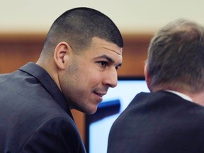 Former New England Patriots NFL football player Aaron Hernandez (L) talks with his lawyer Charles Rankin during his murder trial at Bristol County Superior Court in Fall River, Massachusetts February 26, 2015. (REUTERS/Charles Krupa/Pool)