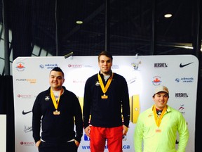 Noah Rolph, centre, stands on a podium after winning gold medals in junior men's weight throw and shot put last weekend at the Hershey Indoor Canadian Track and Field Championships in Montreal. (Contributed photo)