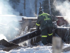 Mathew Robillard, 4 and his sister Melanie Courtney, 2, died in a raging house fire that destroyed a house on Eloi-Lachapelle St. in Gracefield, Quebec late Thursday, Feb. 26, 2015.   Firefighters look through the debris on Friday Feb 27, 2015. 
Tony Caldwell/Ottawa Sun/QMI Agency