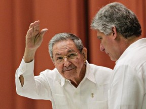 Cuba's President Raul Castro, left, gestures beside first vice-president Miguel Diaz Canel, after delivering a speech to members of the National Assembly in Havana, in this December 20, 2014 file photo. (REUTERS/Stringer)