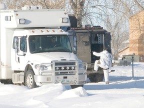 An RCMP officer climbs into the back of a tactical armoured vehicle while investigating a murder on Long Plain First Nation Jan. 2, 2013.  Cody Schmidt, then 21, is charged with manslaughter in the death of Dean Alan Frank Unrau, 24.