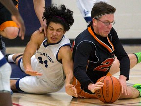 Zach Hunter of Clarke Road, right, beats Nando De La Rosa of CCH to a loose ball during their gold medal WOSSAA AAA boys? basketball game at Catholic Central on Friday. CCH won 40-37. (MIKE HENSEN, The London Free Press )