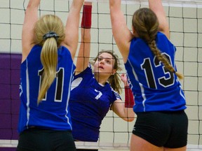 Central?s Brittney Sestric goes for a tip over the combined block of Ingersoll District CI?s Alysha Couch and Morgan Bates during their WOSSAA AAA gold-medal game at Central on Friday. Central won 25-18, 25-22, 25-19. (MIKE HENSEN, The London Free Press)