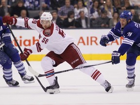 Arizona Coyotes forward Antoine Vermette (50) looks to pass as Toronto Maple Leafs Joffrey Lupul (19) and David Clarkson (71) defend at the Air Canada Centre. (John E. Sokolowski/USA TODAY Sports)